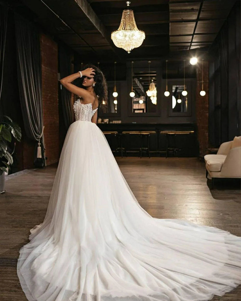 Step into a world of luxury and elegance with the Robe Evaine, a stunning wedding dress adorned with delicate pearls and intricate beading. This court train tulle dress is designed for the daring bride who wants to make a bold statement on her special day. Dare to be different and turn heads with the Robe Evaine!