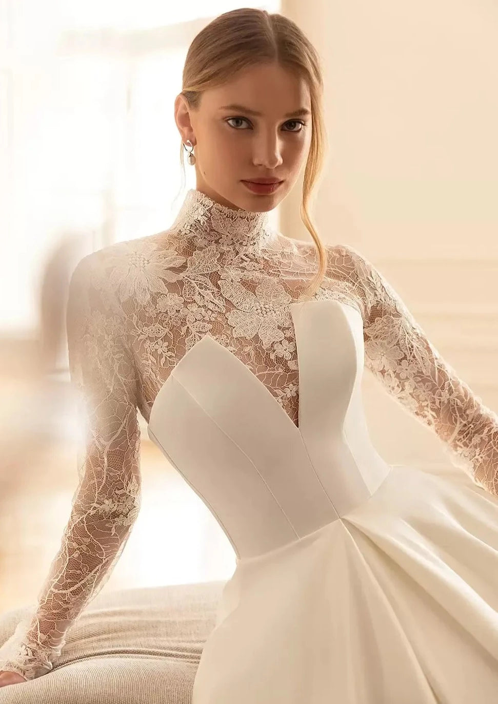 Get ready to walk down the aisle in style with the Robe Milia! This stunning bridal gown features a high neckline and full-length A-line silhouette, perfect for creating a timeless and elegant look. The delicate lace detailing and long sleeves add a touch of romance to this one-of-a-kind dress.&nbsp;