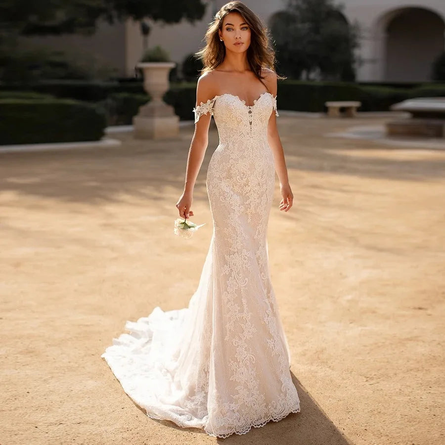 Indulge in luxury and sophistication with our Robe Raine. This elegant off-the-shoulder lace mermaid wedding dress boasts a sweetheart neckline and a sweeping train. Perfect for the discerning bride who wants to make a statement on her special day. Made for women who appreciate timeless beauty and exquisite craftsmanship.