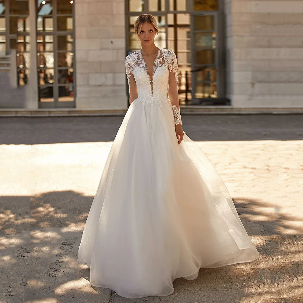 The Robe Angelique is the perfect choice for a vintage-inspired wedding. With delicate lace appliques and long sleeves adorned with buttons, this dress exudes timeless elegance. Feel like a princess on your special day with this stunning bridal dress.