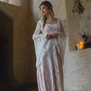 Indulge in luxury with our Robe Solstice, handmade at our exclusive factory. The scoop neck and loose batwing sleeves create a flattering silhouette, while the delicate lace adds an elegant touch. Perfect for a boho-inspired wedding, this dress will make you feel like the most beautiful and unique bride. Custom-made just for you.