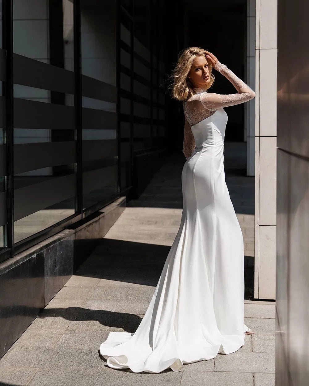 Indulge in the luxury of our Robe Pascale. Made with soft satin and delicate lace, this mermaid wedding dress combines sophistication and sensuality. The high neck and long sleeves add a touch of elegance to this stunning piece, perfect for the modern bride. Experience the perfect blend of art and design.