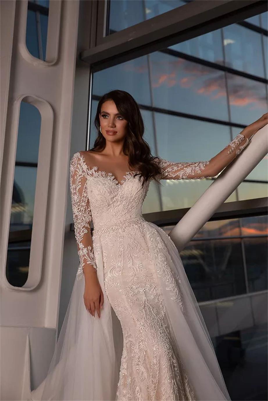 Look like a goddess in the Robe Adriene, a luxury bridal gown with dazzling crystal accents and a gorgeous mermaid silhouette. With its soft and flowing long sleeves, you'll feel beautiful and graceful as you make your grand entrance. Make a stunning impression on your special day!