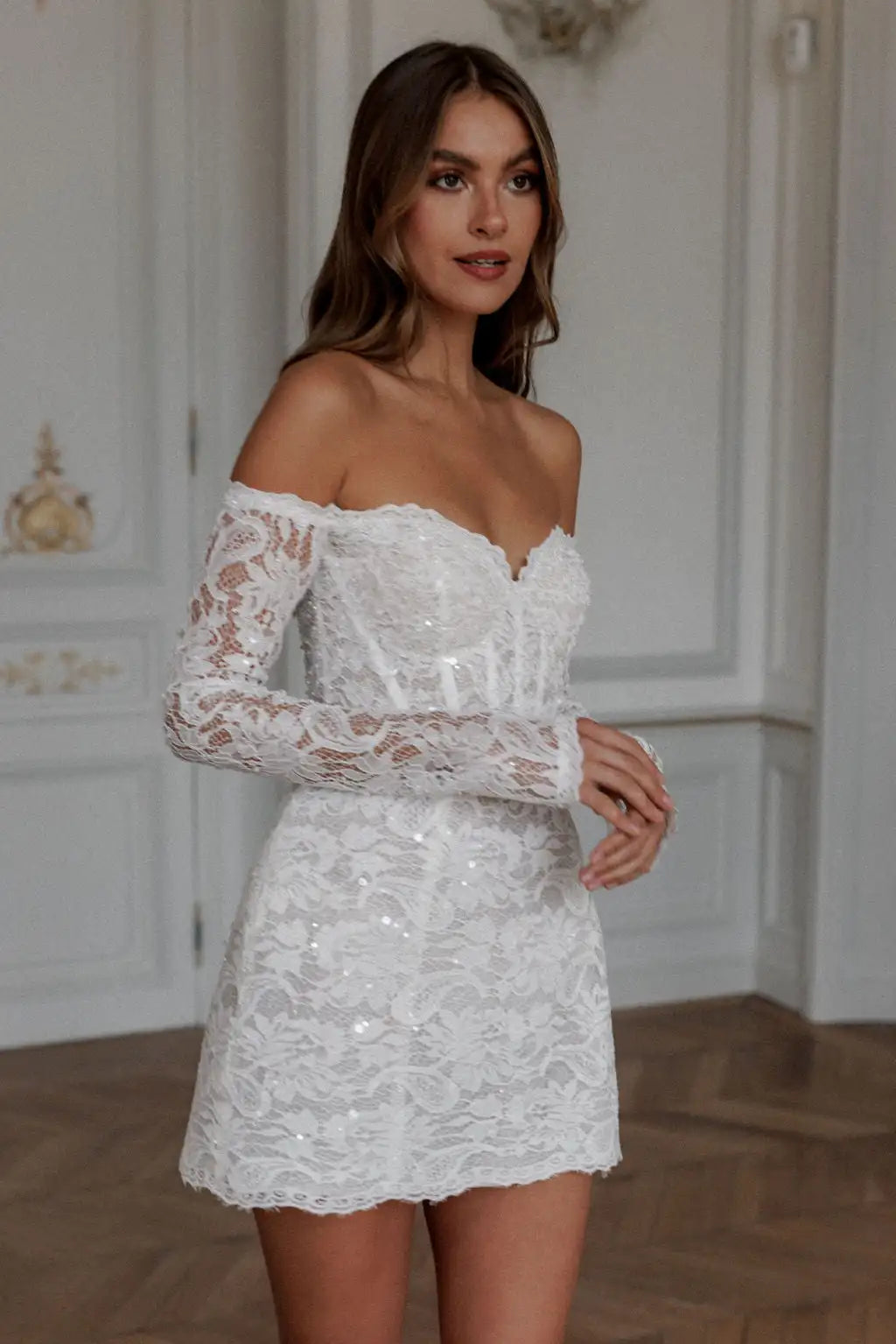 Expertly crafted with lace appliques and an elegant off shoulder design, the Robe Noemie is the perfect choice for any special occasion. The heart shaped neck adds a touch of romance to this elegant white mini dress. Make a statement and feel confident and beautiful all night long.