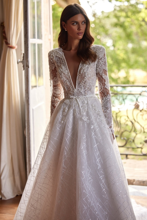 Indulge in pure elegance with our Mirae Gown. This chic A-line gown is designed to sparkle and captivate, making it the perfect choice for any bridal occasion. Its romantic silhouette will make you feel like a true princess on your special day. Upgrade your bridal look with this stunning dress.